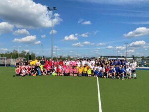 Group of people on a hockey pitch
